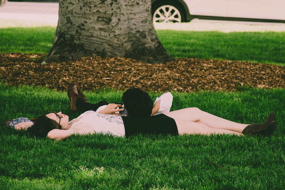 穿白草帽的女人躺在青草上