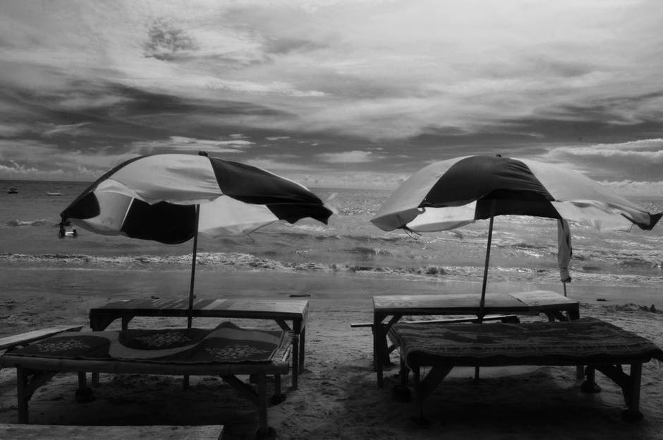 海边两张野餐桌的灰度摄影