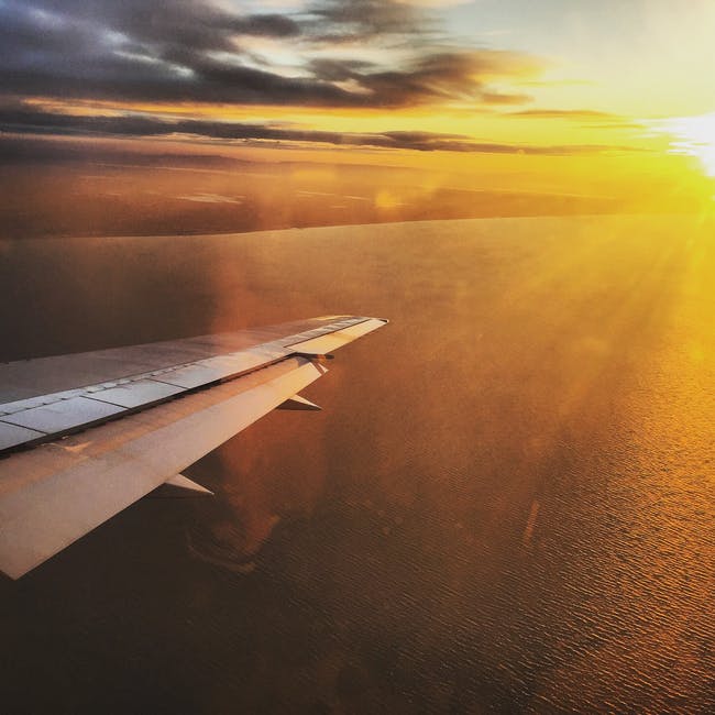 日落时飞机机翼的航空摄影